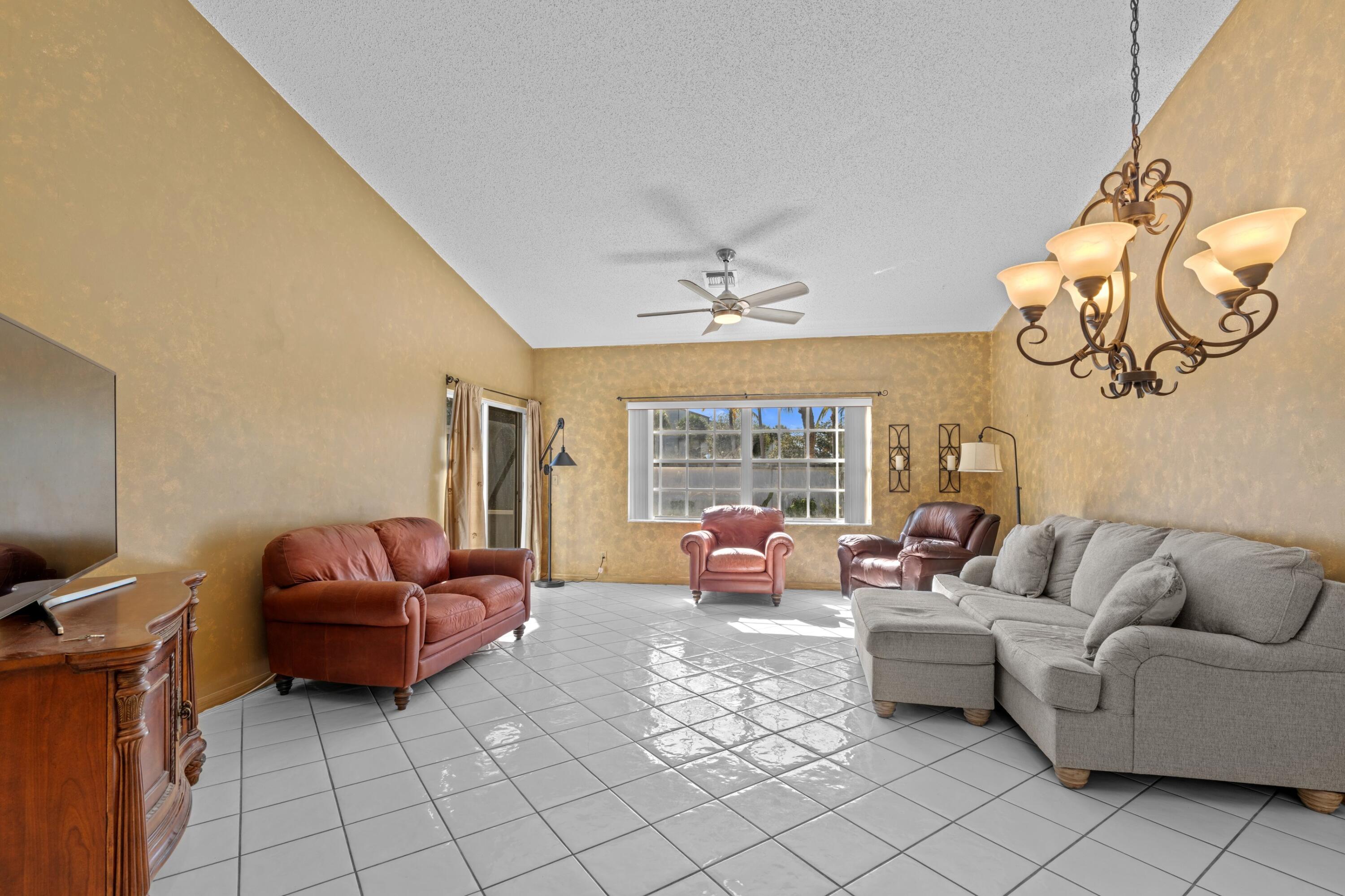 5140 Sabal Gardens Lane, Unit 2 Boca Raton, FL 33487 - Photo 8 of 34 a living room with furniture and a chandelier