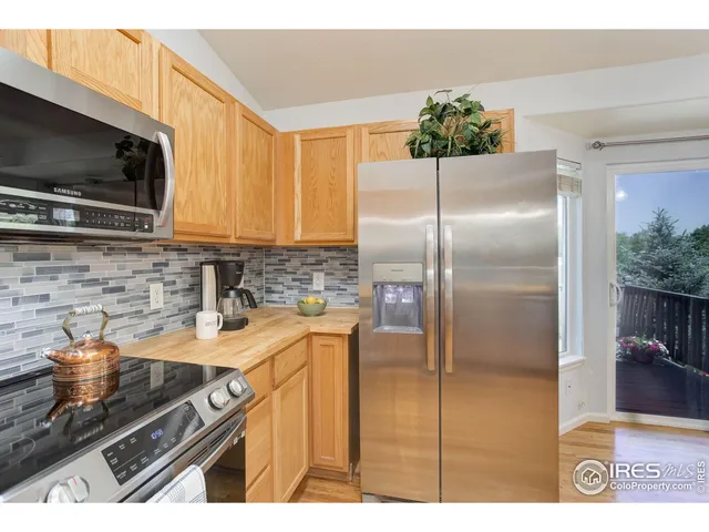 a kitchen with kitchen island granite countertop a sink stainless steel appliances and a counter top space