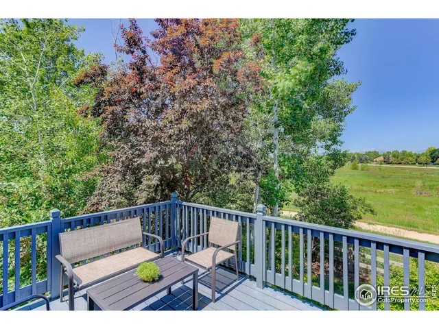a view of balcony with wooden floor and outdoor seating