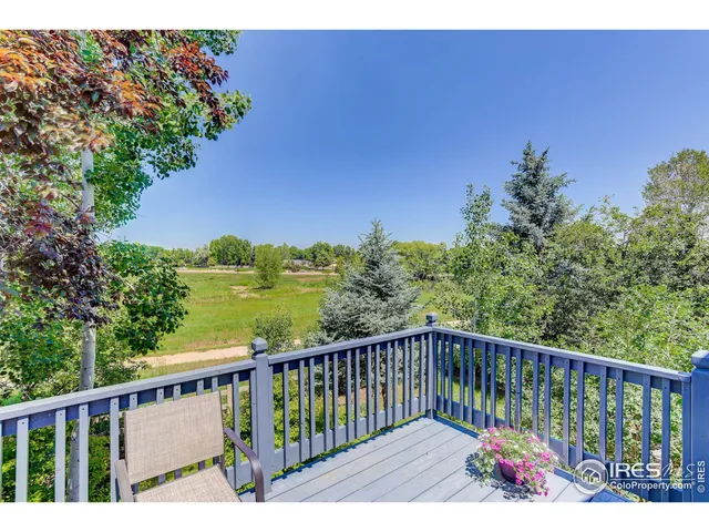 a view of balcony with wooden floor and outdoor seating