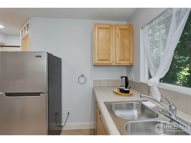 a kitchen with refrigerator and window
