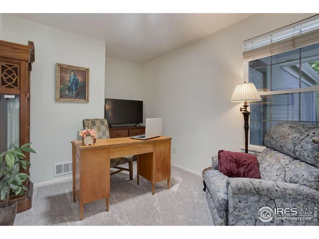 a balcony with furniture and a potted plant