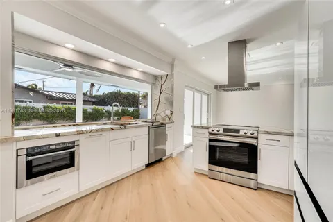 a kitchen with a stove a sink and a refrigerator