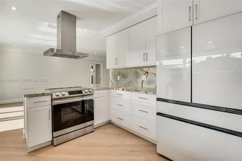 a kitchen with cabinets stainless steel appliances and a counter space