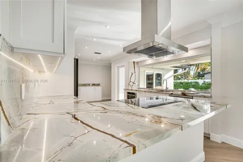 a living room with kitchen island granite countertop furniture and a fireplace