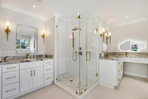 a white bath tub sitting next to a white sink