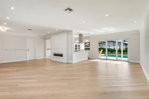 a living room with kitchen island granite countertop furniture and a fireplace
