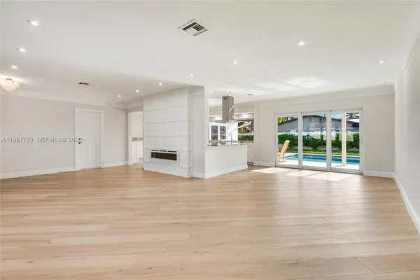 a living room with kitchen island granite countertop furniture and a fireplace