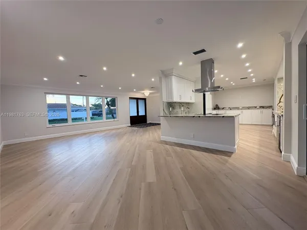 a bathroom with a granite countertop sink mirror and shower