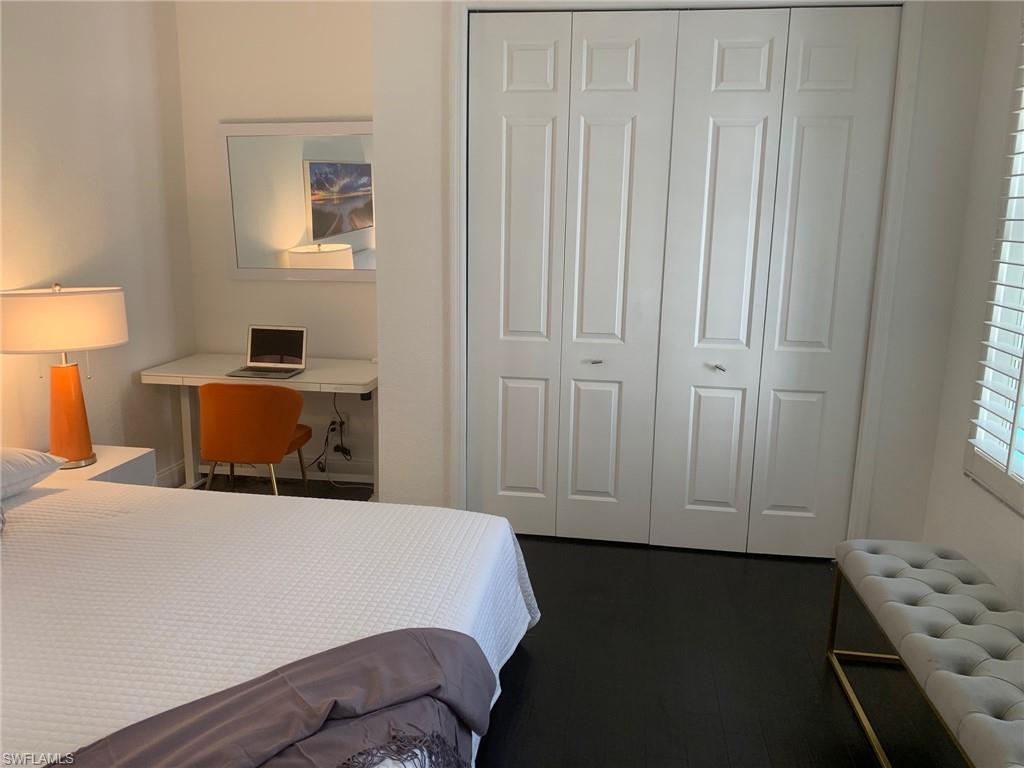 6537 Ilex Circle Naples, FL 34109 - Photo 11 of 28 a bedroom with a bed and wooden floor