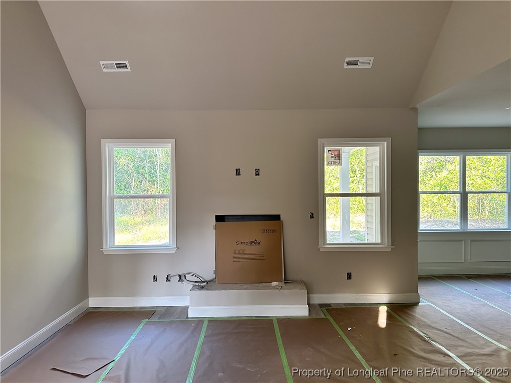 2 Collier Road Wade, NC 28395 - Photo 5 of 18 a view of an empty room with wooden floor and a window
