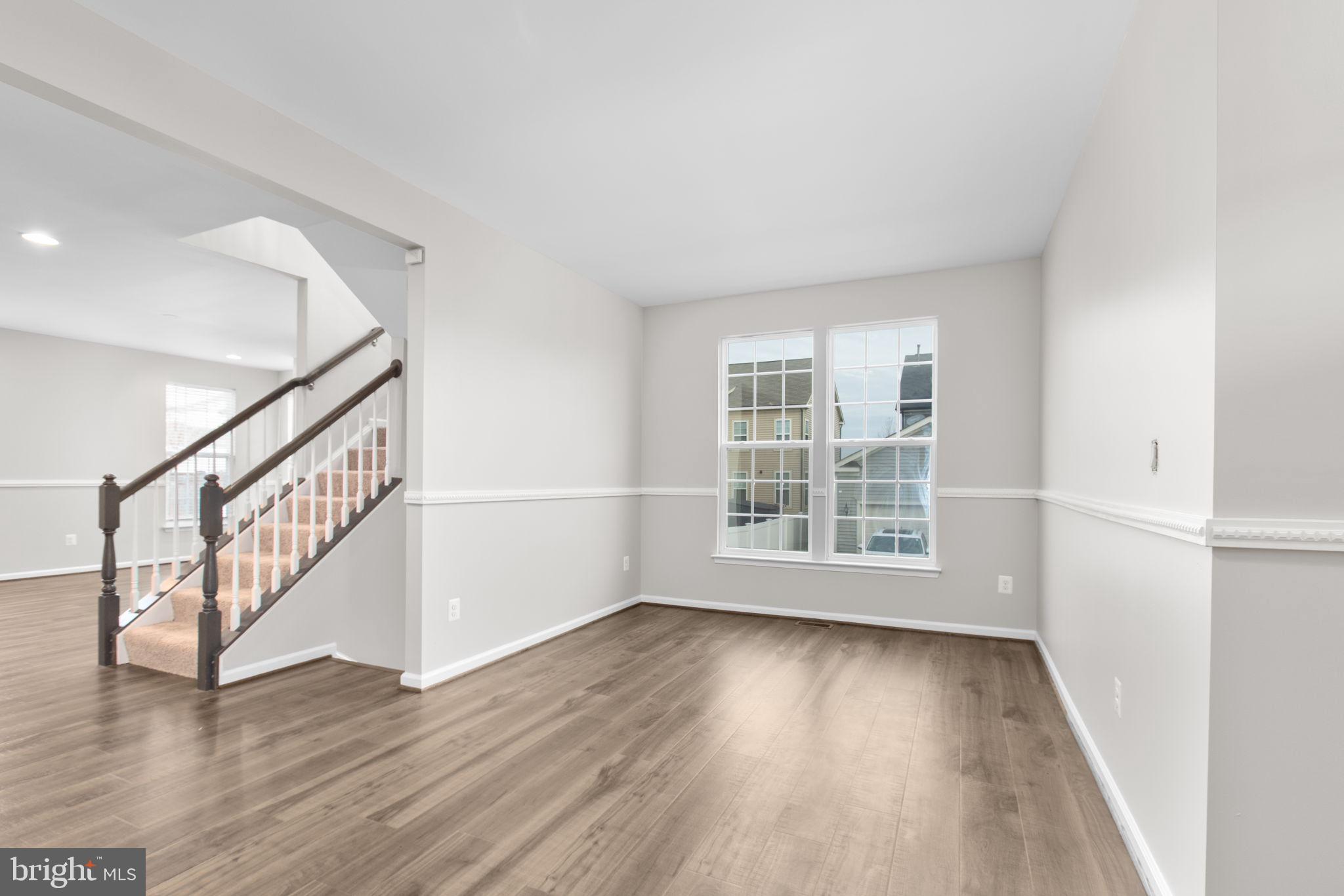 930 Forsythia Lane Stafford, VA 22554 - Photo 12 of 81 a view of an empty room with wooden floor and a window