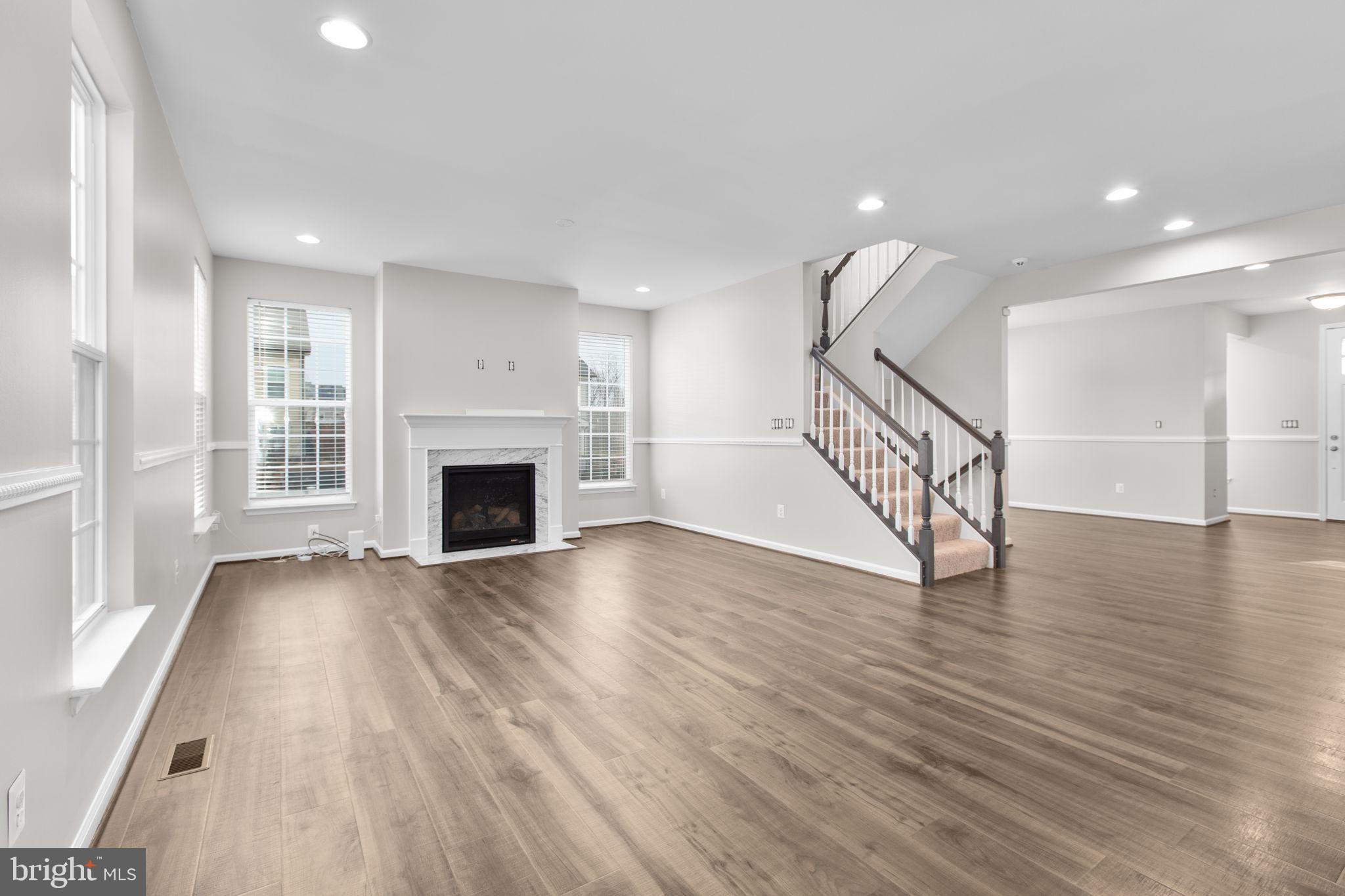 930 Forsythia Lane Stafford, VA 22554 - Photo 21 of 81 an empty room with wooden floor and fireplace