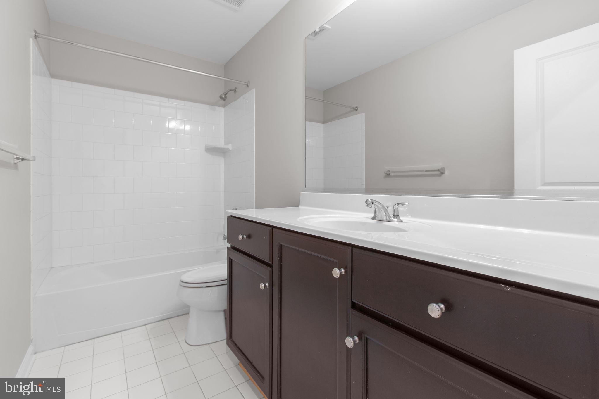 930 Forsythia Lane Stafford, VA 22554 - Photo 33 of 81 a spacious bathroom with a double vanity sink a toilet and a mirror