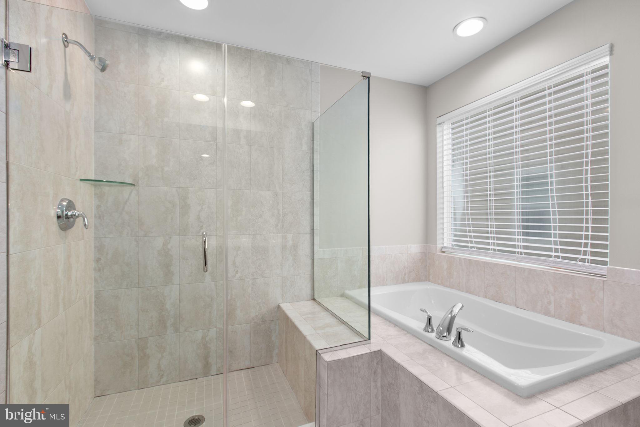 930 Forsythia Lane Stafford, VA 22554 - Photo 38 of 81 a bathroom with a tub a sink and a window