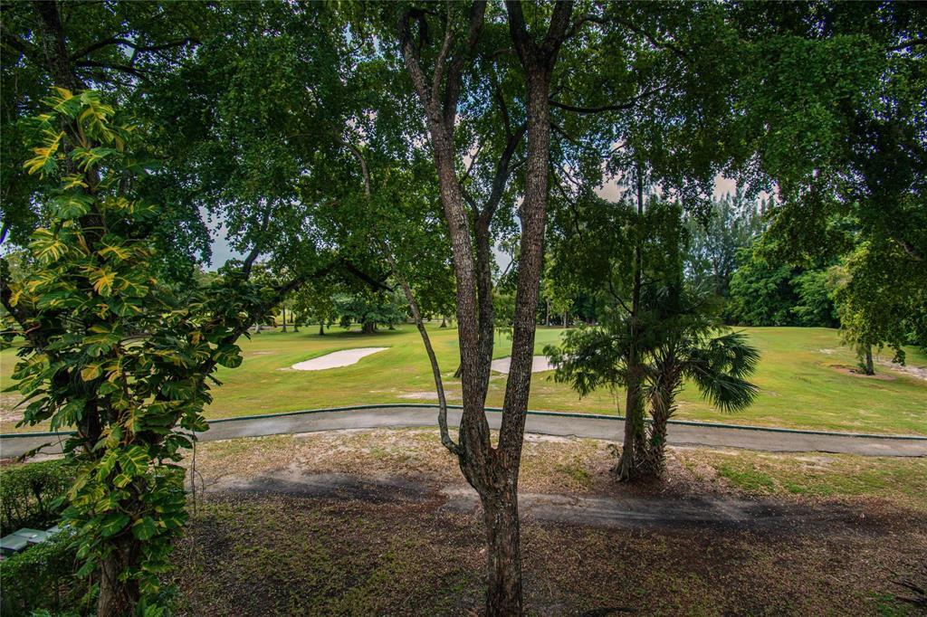 8150 West McNab Road, Unit 312 Tamarac, FL 33321 - Photo 21 of 32 a view of a yard with trees
