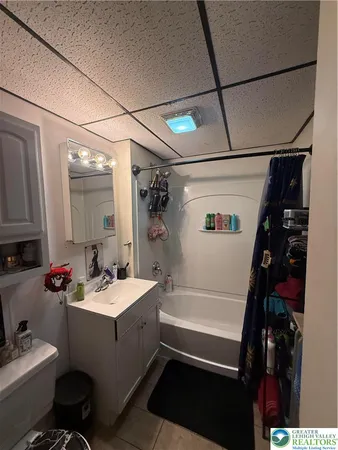 a bathroom with a sink toilet vanity and tub