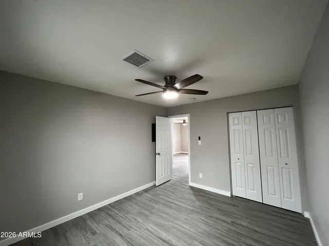 a view of an empty room and wooden floor