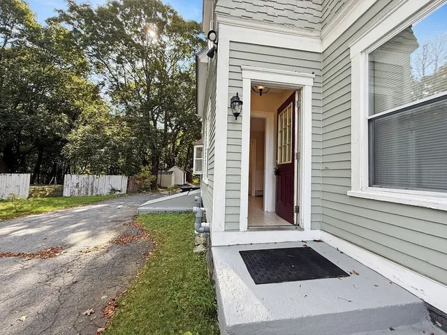a view of a house with backyard and sitting area