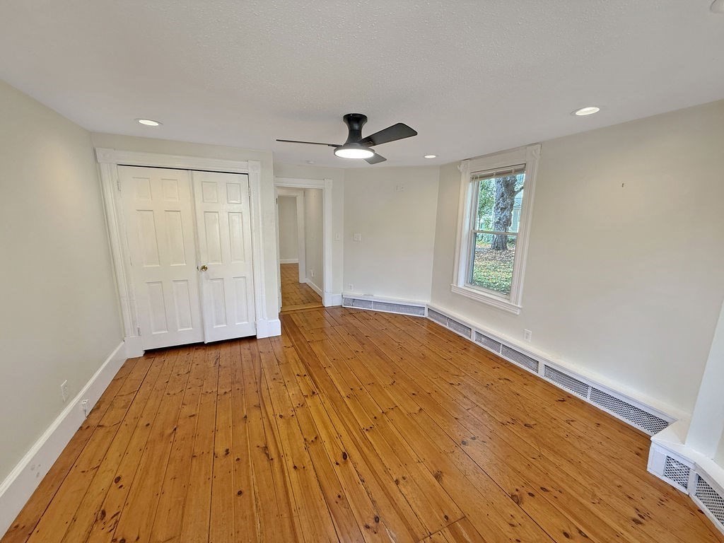 52 Littleton Road, Unit 1 Chelmsford, MA 01824 - Photo 22 of 40 wooden floor in an empty room with a window