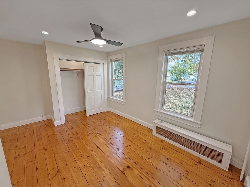 52 Littleton Road, Unit 1 Chelmsford, MA 01824 - Photo 30 of 40 a view of an empty room with wooden floor and a window