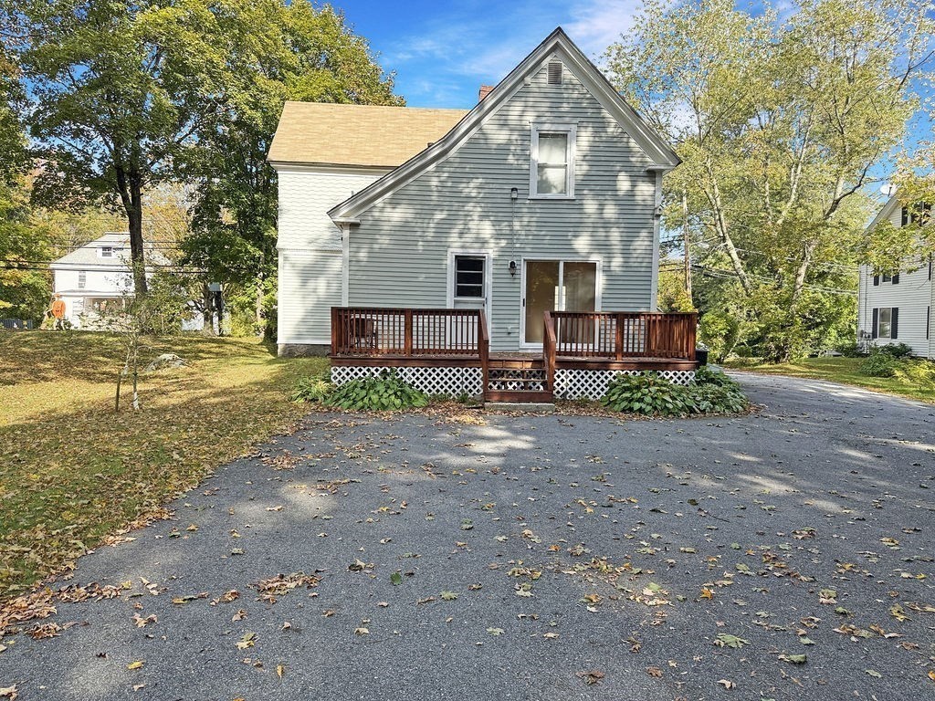 52 Littleton Road, Unit 1 Chelmsford, MA 01824 - Photo 35 of 40 a front view of a house with a yard and garage