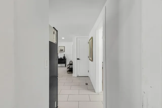 a kitchen with white cabinets and white appliances