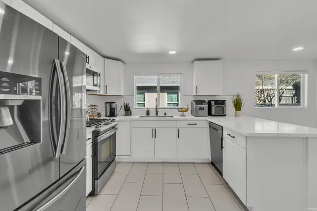 a kitchen with appliances cabinets and a sink