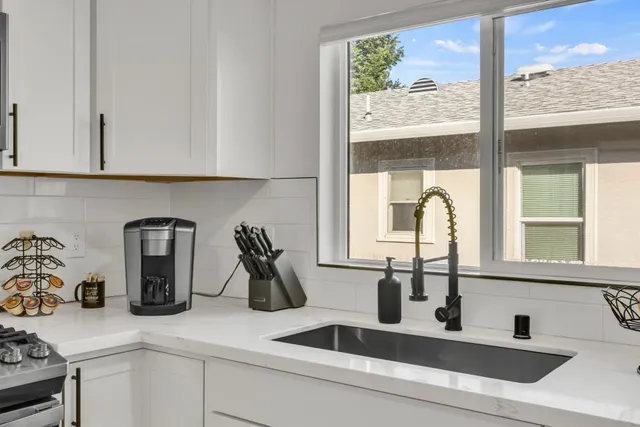 a kitchen with a stove and a white cabinets