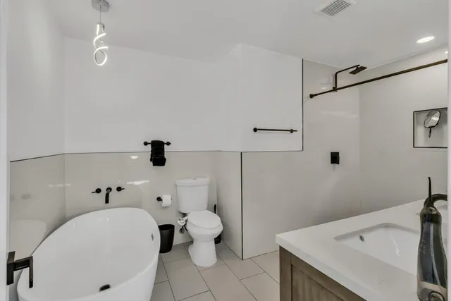 a bathroom with a granite countertop double vanity sink and a mirror