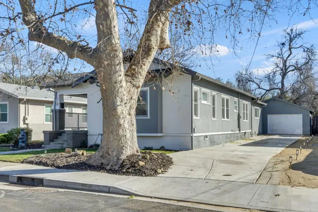 a front view of a house with trees
