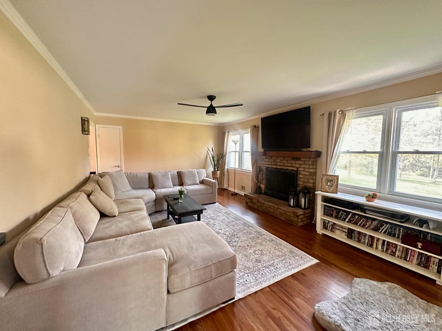 667 Cedarbrook Road Bridgewater, NJ 08807 - Photo 12 of 24 a living room with furniture flat screen tv and a fireplace