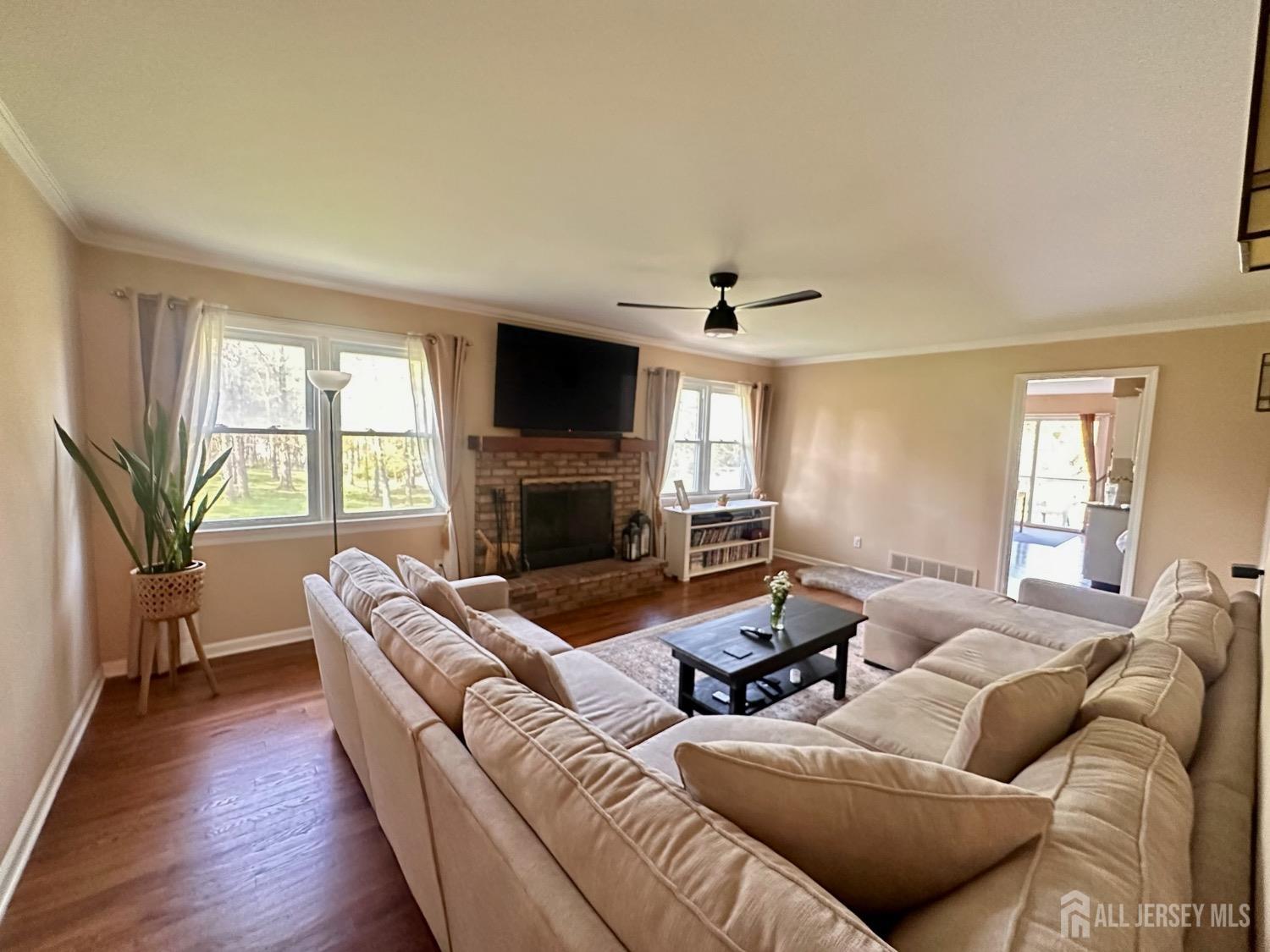 667 Cedarbrook Road Bridgewater, NJ 08807 - Photo 13 of 24 a living room with furniture fireplace and a flat screen tv