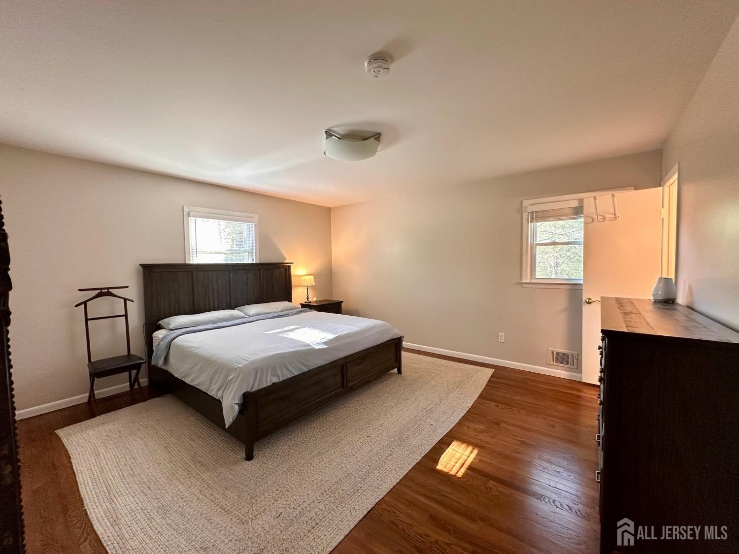 667 Cedarbrook Road Bridgewater, NJ 08807 - Photo 14 of 24 a bedroom with a bed and wooden floor