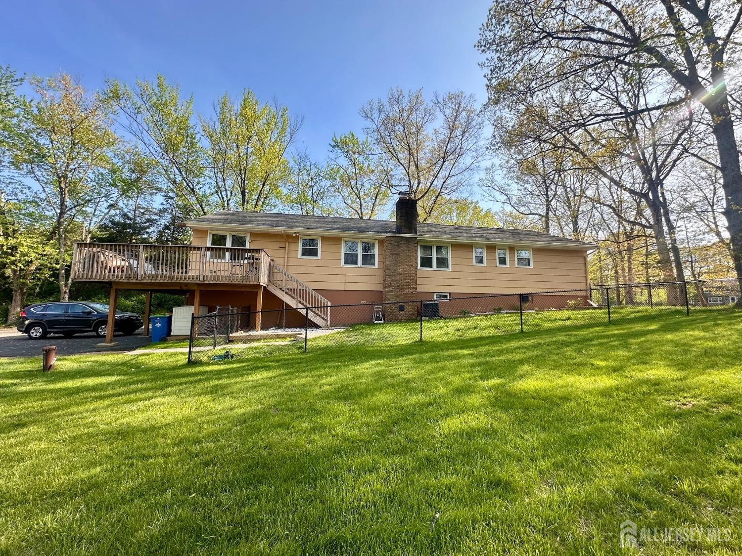 667 Cedarbrook Road Bridgewater, NJ 08807 - Photo 4 of 24 a view of a house with a big yard and sitting area