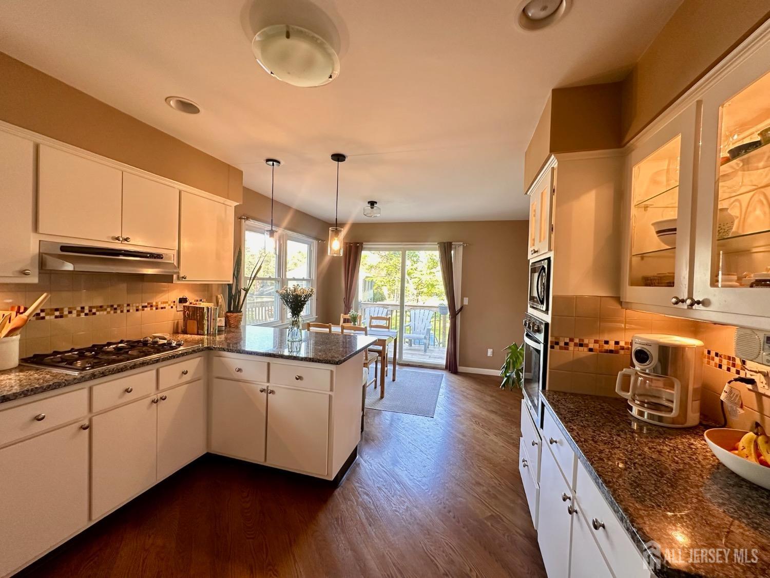 667 Cedarbrook Road Bridgewater, NJ 08807 - Photo 10 of 24 a large kitchen with stainless steel appliances granite countertop a lot of counter space and wooden floors