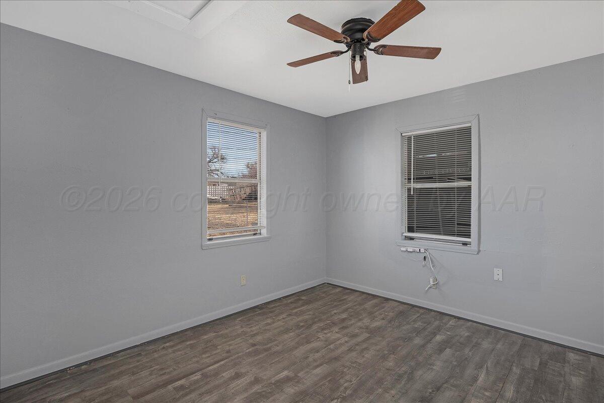 1108 North Madison Street Amarillo, TX 79107 - Photo 13 of 22 a view of empty room with wooden floor and fan