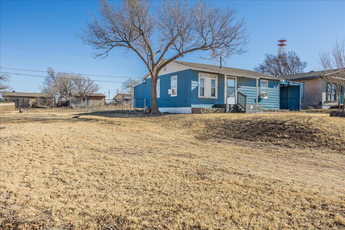 1108 North Madison Street Amarillo, TX 79107 - Photo 2 of 21 a front view of a house with a yard