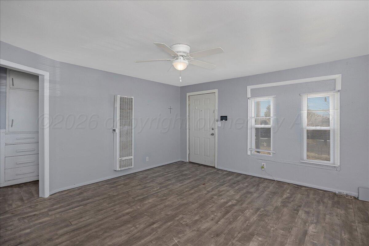 1108 North Madison Street Amarillo, TX 79107 - Photo 4 of 22 a view of empty room with wooden floor and fan