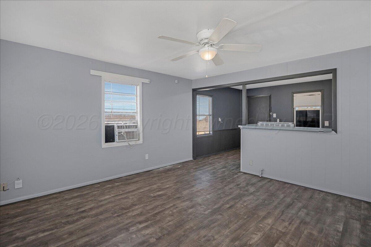 1108 North Madison Street Amarillo, TX 79107 - Photo 6 of 21 a view of a kitchen with a sink hardwood floor and a living room