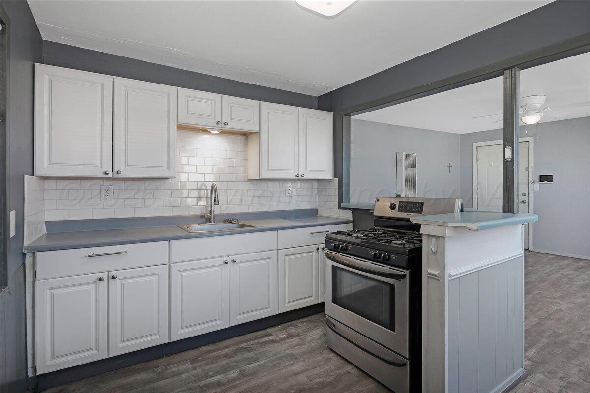 1108 North Madison Street Amarillo, TX 79107 - Photo 9 of 22 a kitchen with granite countertop white cabinets and appliances