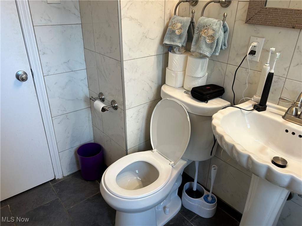 1407 Cranover Road Cleveland, OH 44124 - Photo 24 of 44 Bathroom featuring tile patterned flooring, tile walls, and toilet