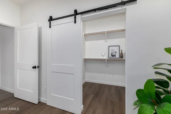 a bedroom with a bed and a potted plant