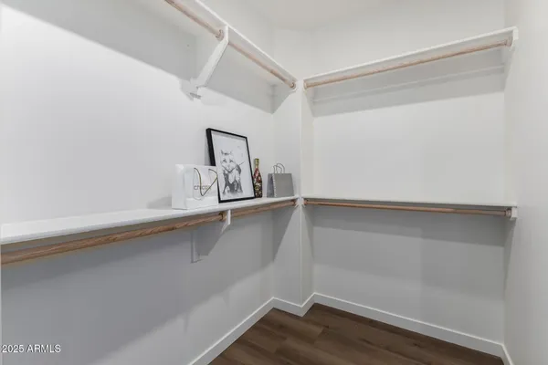 a view of walk in closet with empty racks