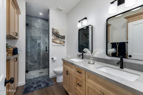 a bed sitting in a bedroom next to a window and a chandelier