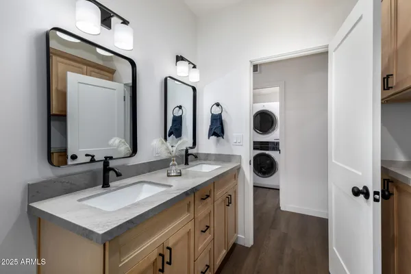 a bathroom with double sink and a mirror