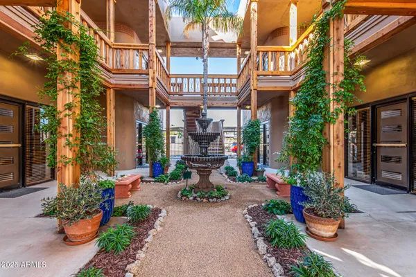 a front view of a house with a garden and seating area