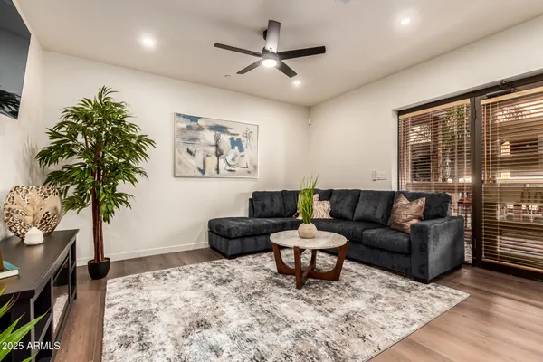 a living room kitchen with furniture and a kitchen view