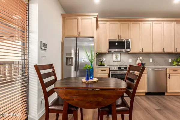 a kitchen with a sink stove and wooden floor