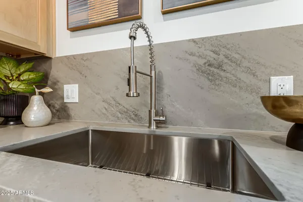 a kitchen with a dining table chairs and refrigerator